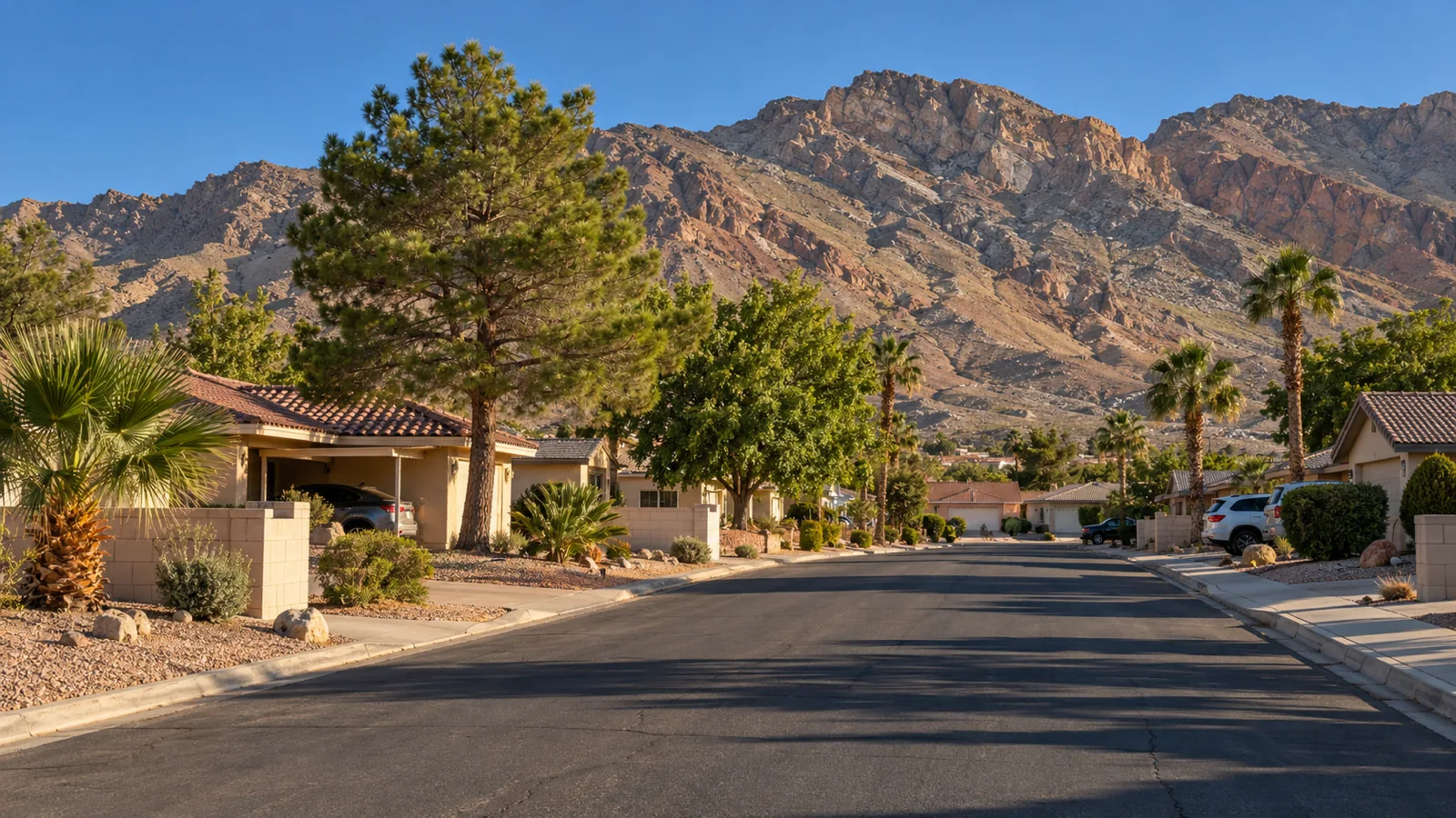 Older single-storey ranch homes in Sunrise Manor, NV with Frenchman Mountain on the eastern horizon in evening light